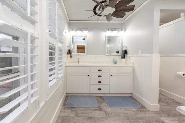 a bathroom with a sink a mirror and a shower