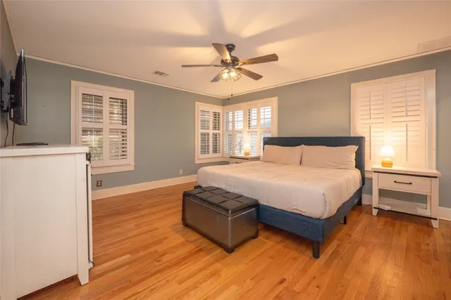 a spacious bedroom with a bed and window
