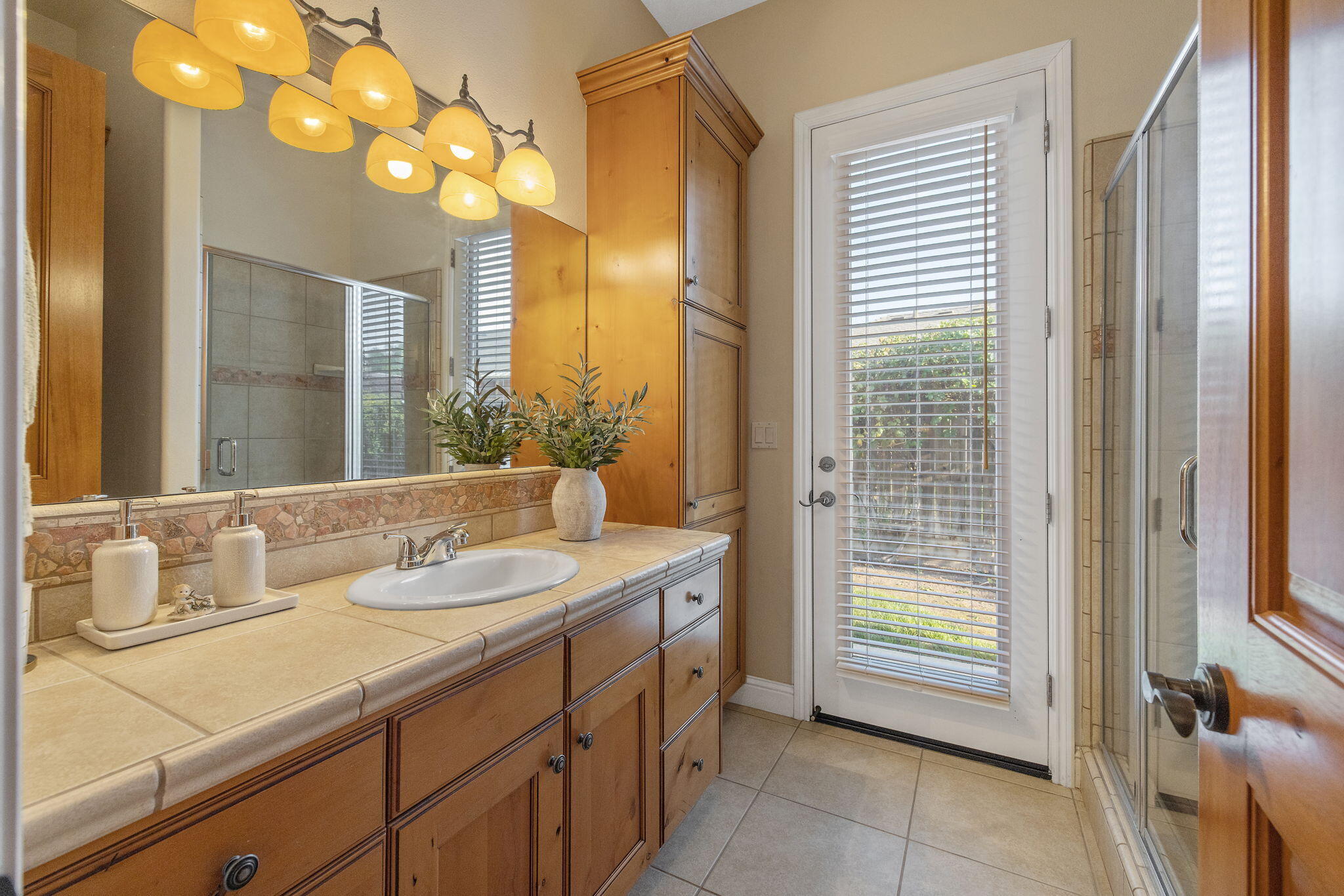 729 St Thomas Court Exeter, CA 93221 - Photo 39 of 66 a bathroom with a granite countertop sink and a mirror