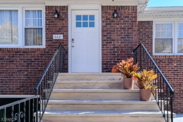 a view of entryway with wooden floor and a front door