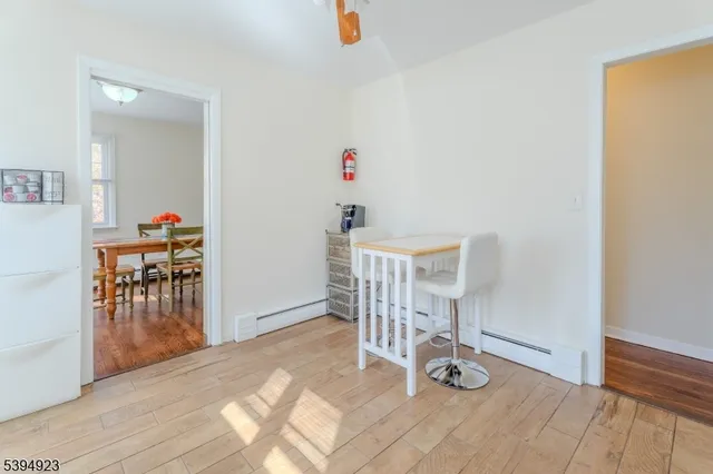 a view of a room with wooden floor and furniture