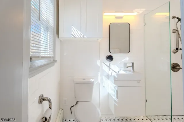a bathroom with a toilet sink and shower
