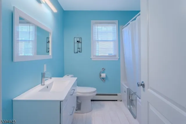 a bathroom with a sink a toilet and tub