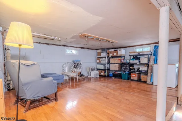 a living room with lots of furniture and a wooden floor