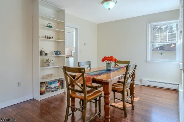 a dining room with furniture and wooden floor