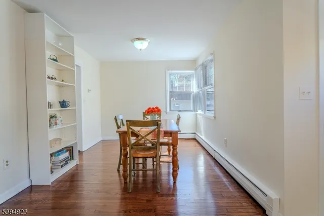 a dining room with furniture and wooden floor