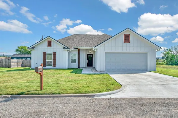 a view of a house with a backyard and porch