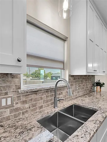 a kitchen with a sink a counter and cabinets