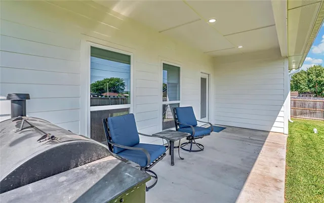 a view of a workspace with furniture and lounge chair