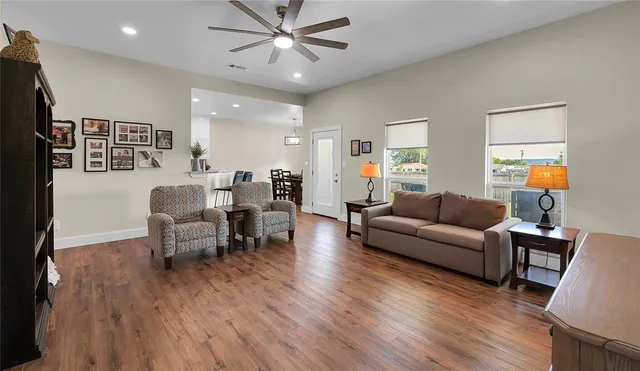 a living room with furniture and a wooden floor