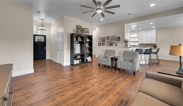 a living room with furniture and a wooden floor