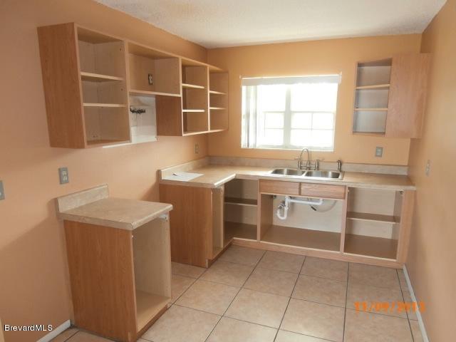 265 Benchor Road Northwest Palm Bay, FL 32907 - Photo 14 of 14 a utility room with cabinets washer and dryer