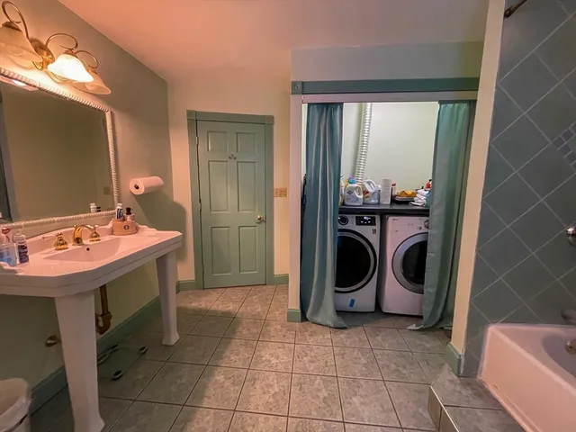 a utility room with closet a washer and dryer