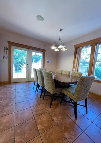 a view of a dining room with furniture and chandelier