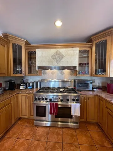 a kitchen with stainless steel appliances a stove top oven and sink