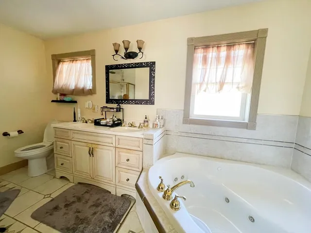 a bathroom with a bathtub sink and toilet