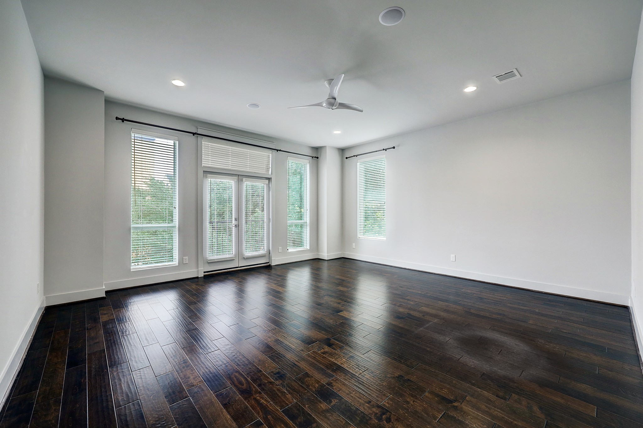 609 West Pierce Street Houston, TX 77019 - Photo 12 of 32 a view of an empty room with wooden floor and a window