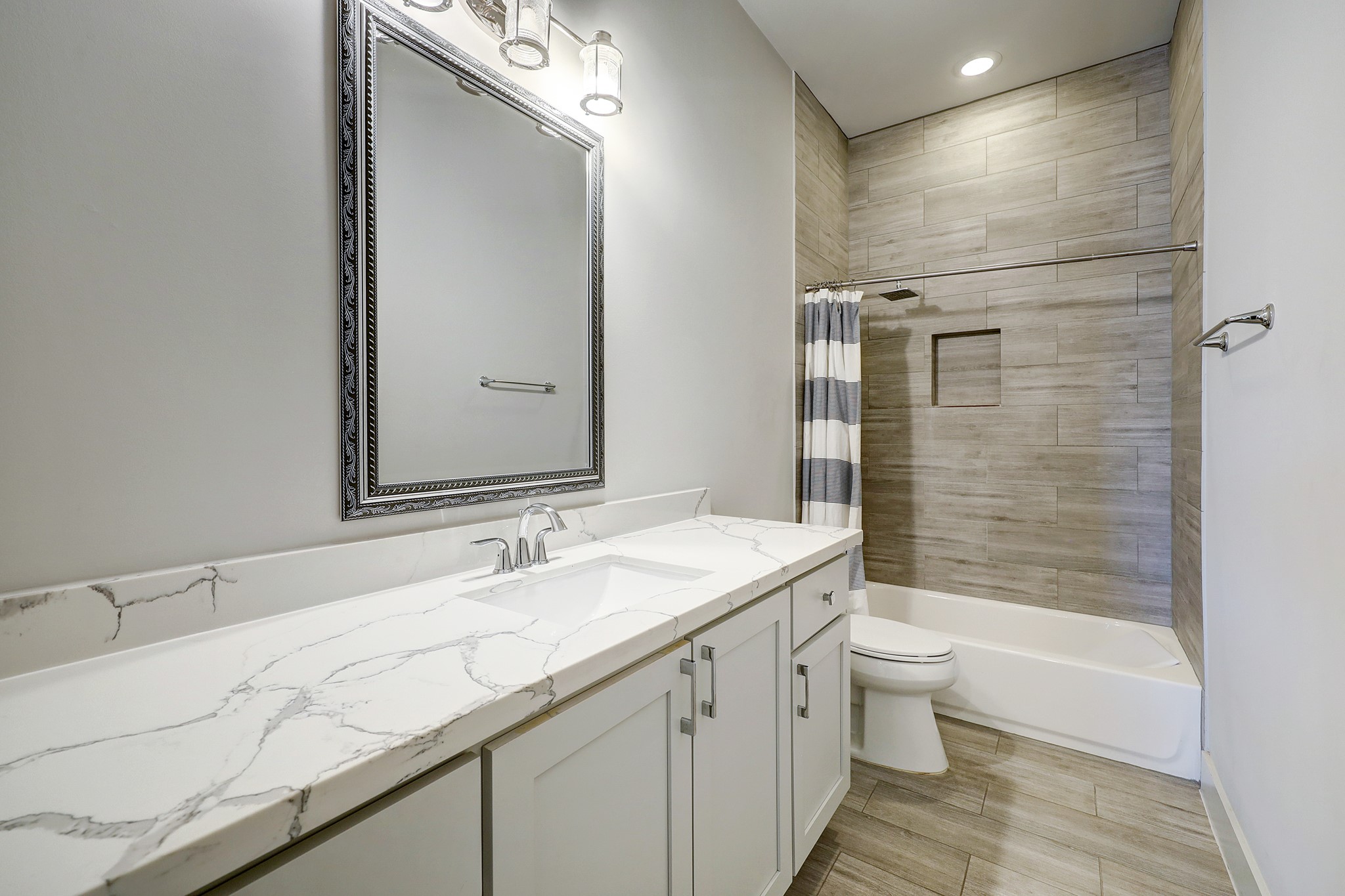 609 West Pierce Street Houston, TX 77019 - Photo 22 of 32 a bathroom with a granite countertop sink a toilet and shower