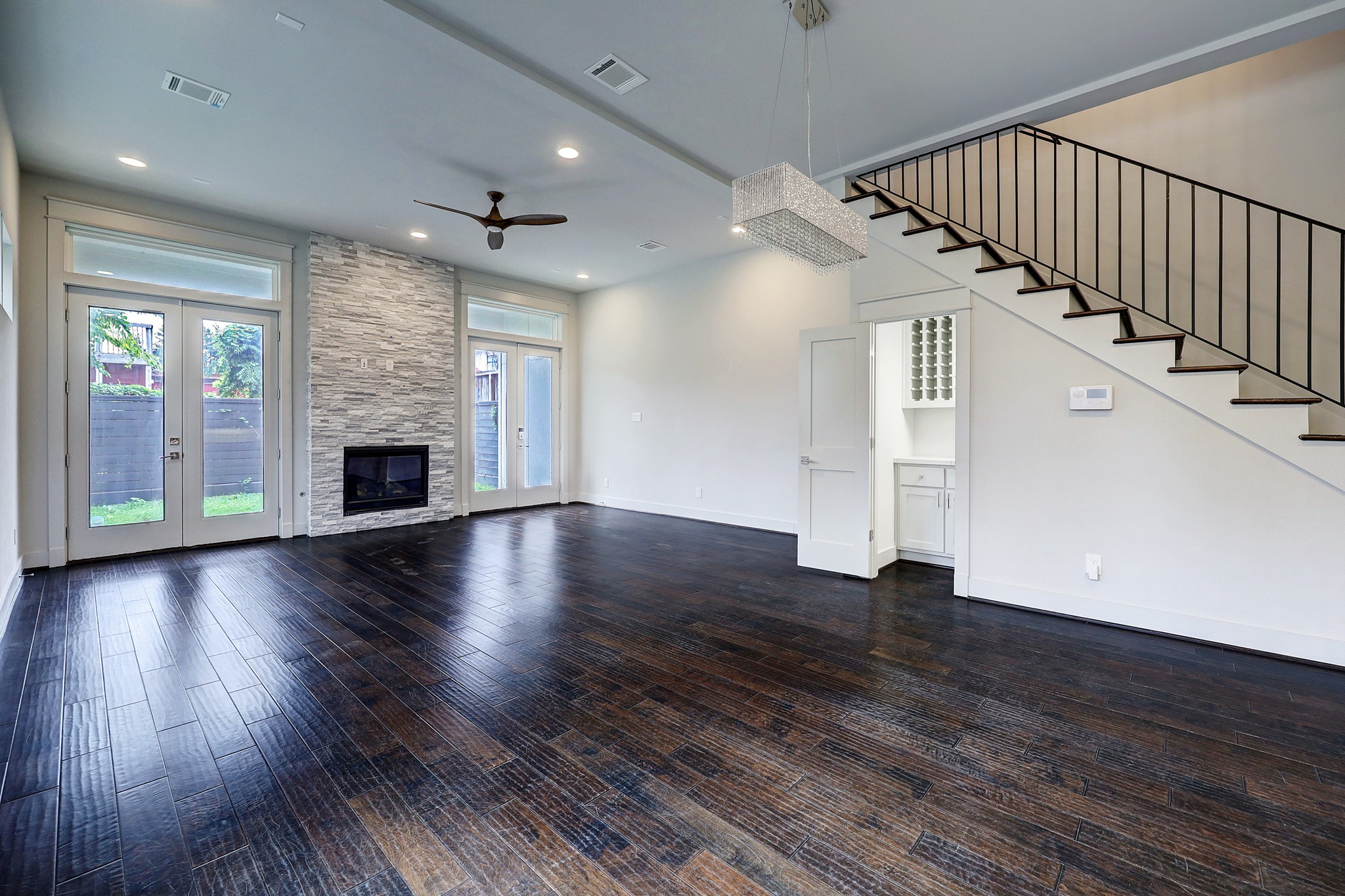 609 West Pierce Street Houston, TX 77019 - Photo 4 of 32 an empty room with wooden floor fireplace and windows