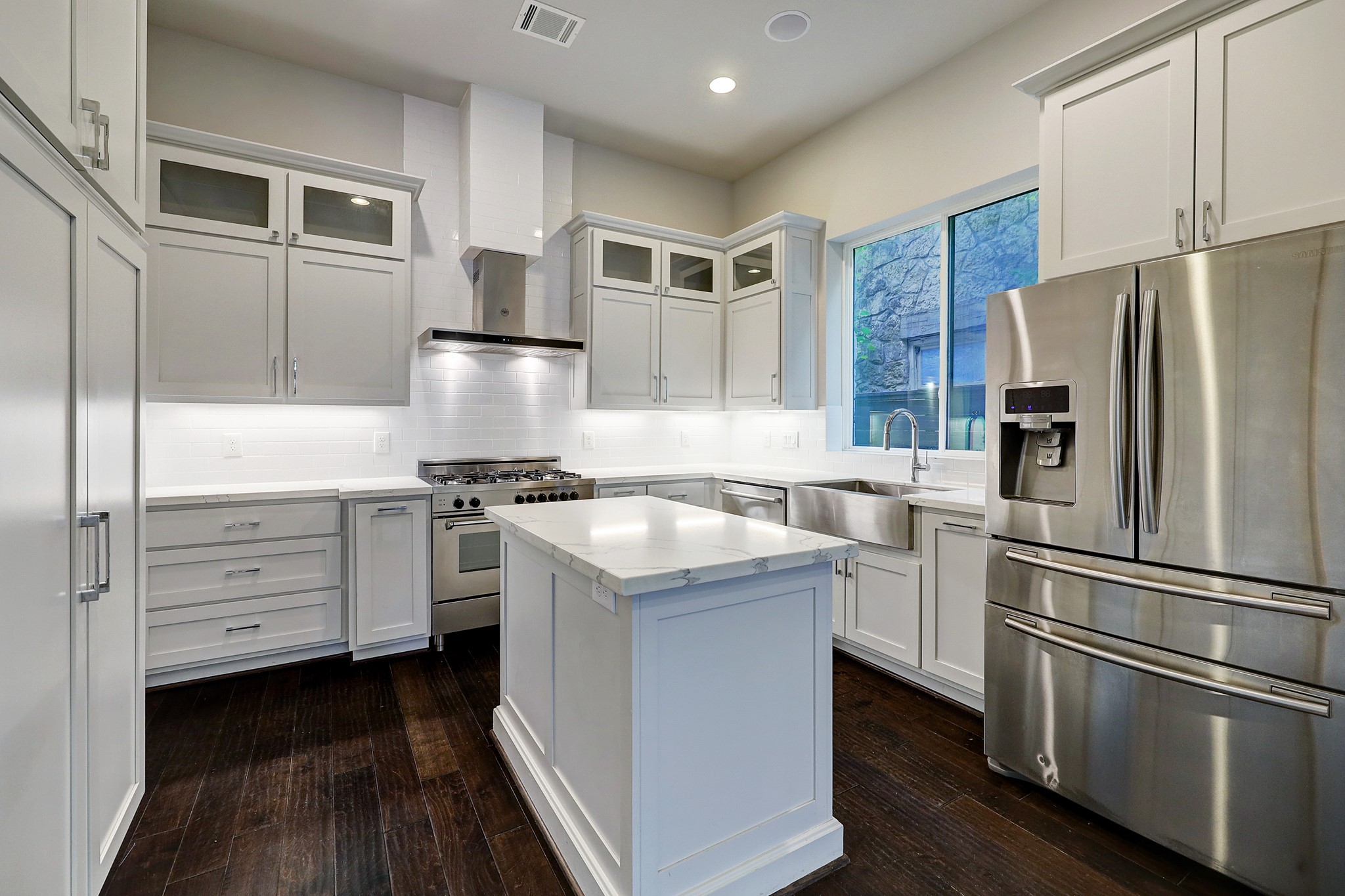 609 West Pierce Street Houston, TX 77019 - Photo 6 of 32 a kitchen with a refrigerator stove and wooden cabinets