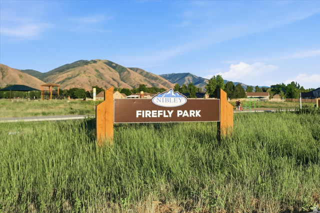 2257 South 1090 West, Unit 74 Nibley, UT 84321 - Photo 30 of 40 Nibley Firefly Park sign with mountain backdrop
