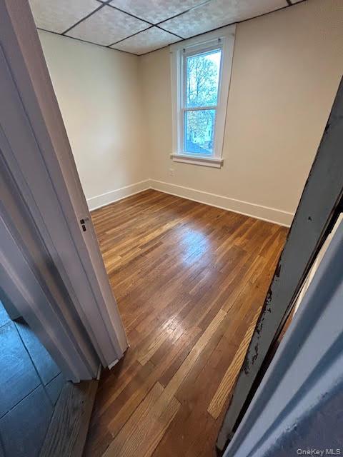 198 Knickerbocker Avenue Rochester, NY 14615 - Photo 12 of 13 a view of an empty room with wooden floor and a window