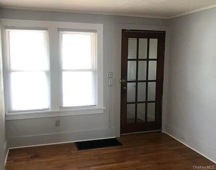 198 Knickerbocker Avenue Rochester, NY 14615 - Photo 2 of 13 a view of an empty room with wooden floor and a window