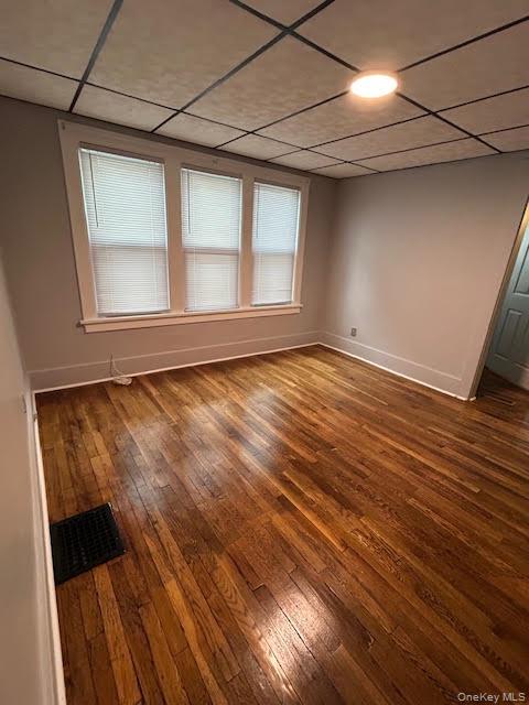 198 Knickerbocker Avenue Rochester, NY 14615 - Photo 8 of 13 a view of an empty room with wooden floor and a window