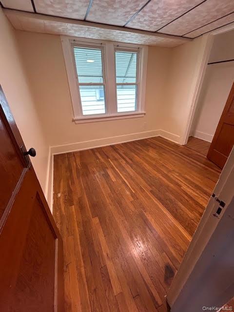 198 Knickerbocker Avenue Rochester, NY 14615 - Photo 9 of 13 a view of an empty room with wooden floor and a window