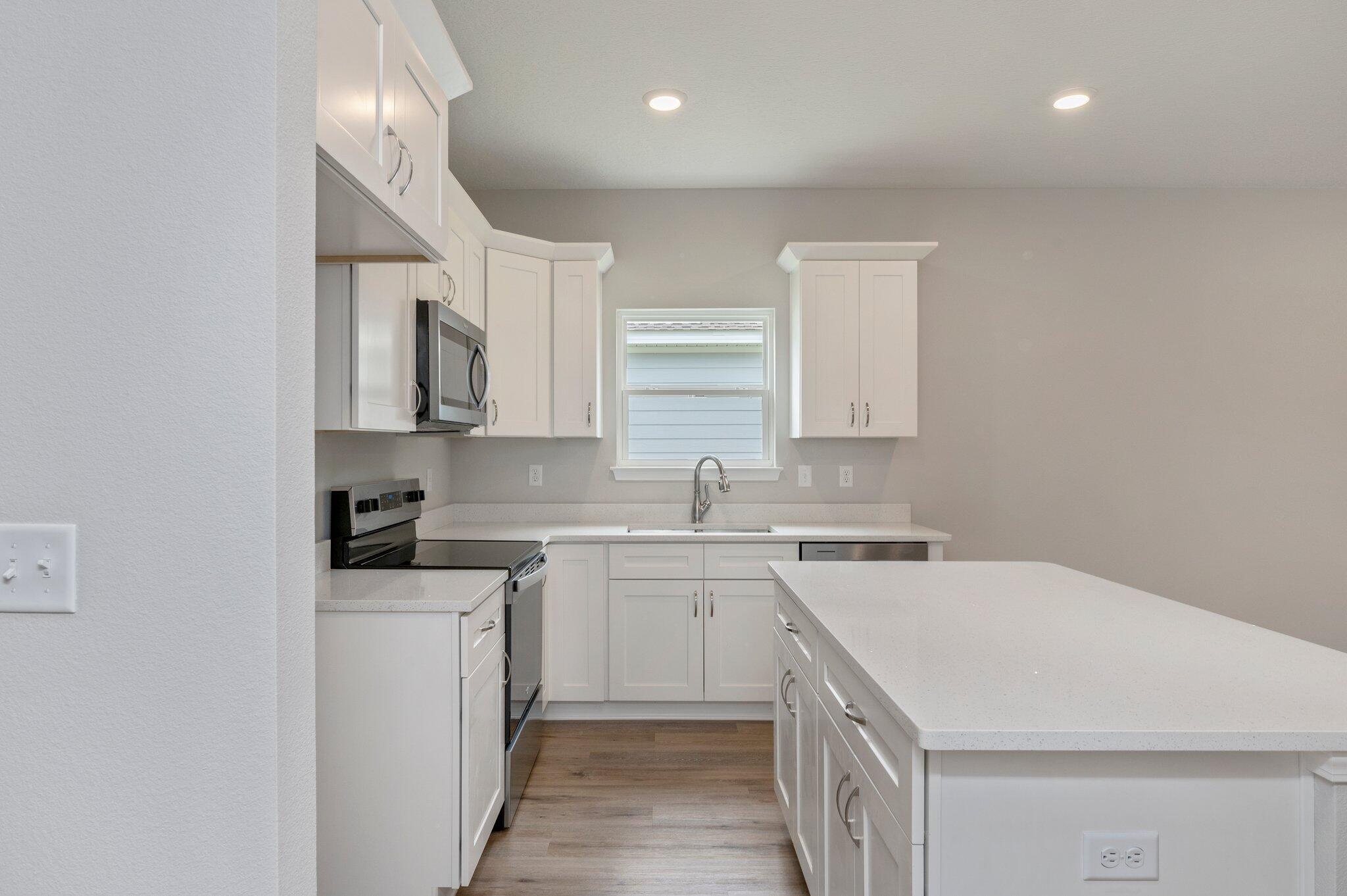 95 Live Oak Street Freeport, FL 32439 - Photo 11 of 26 a kitchen with a sink stove and cabinets