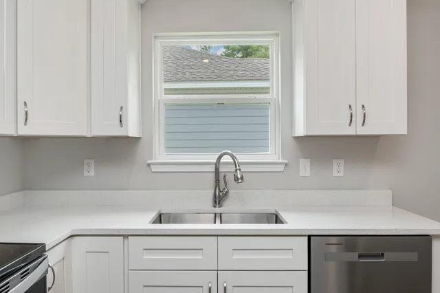 a kitchen with appliances cabinets and a sink