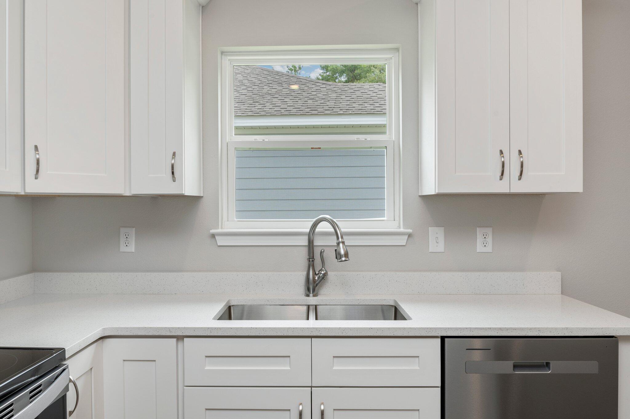 95 Live Oak Street Freeport, FL 32439 - Photo 12 of 26 a kitchen with appliances cabinets and a sink