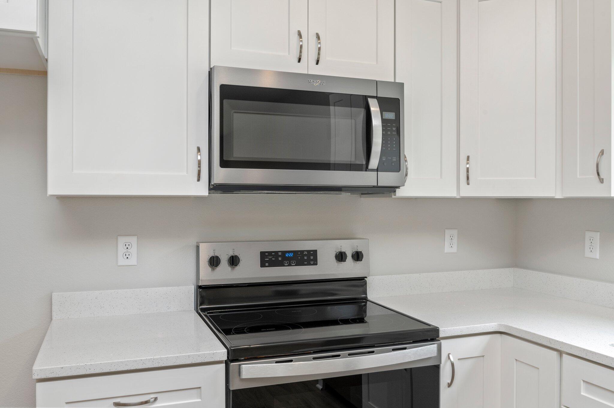 95 Live Oak Street Freeport, FL 32439 - Photo 13 of 26 a kitchen with appliances and cabinets
