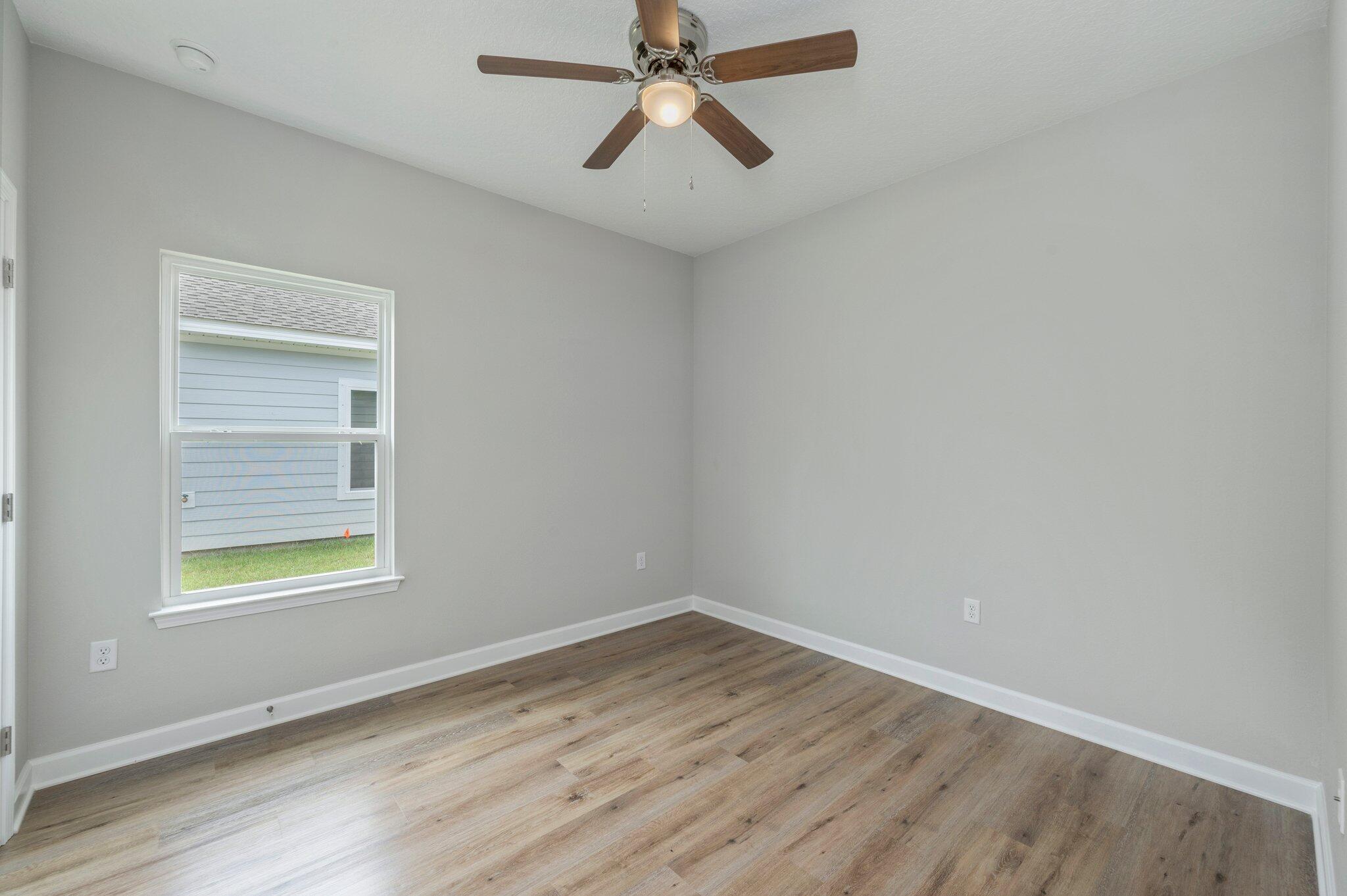 95 Live Oak Street Freeport, FL 32439 - Photo 14 of 26 an empty room with a window and a ceiling fan