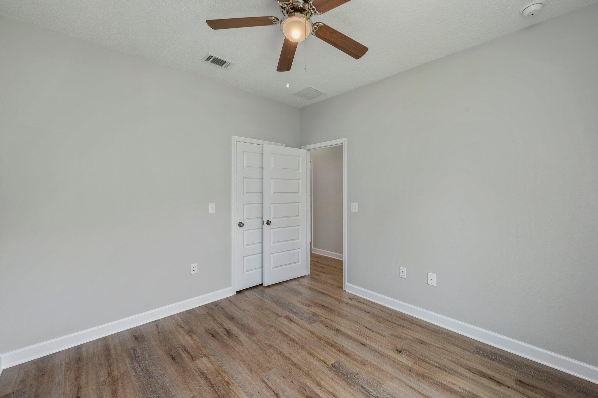 95 Live Oak Street Freeport, FL 32439 - Photo 17 of 26 a view of an empty room with wooden floor