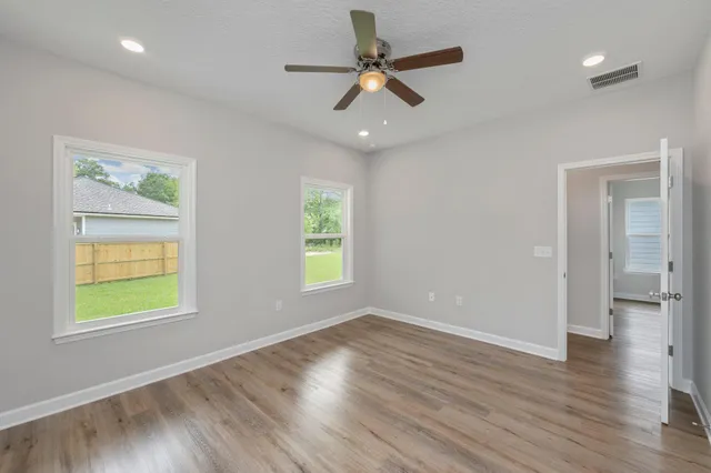 wooden floor in an empty room with a window