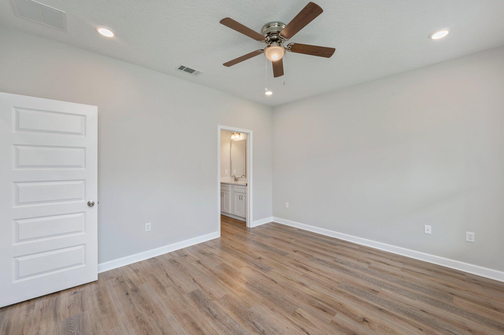 95 Live Oak Street Freeport, FL 32439 - Photo 22 of 26 an empty room with wooden floor and windows