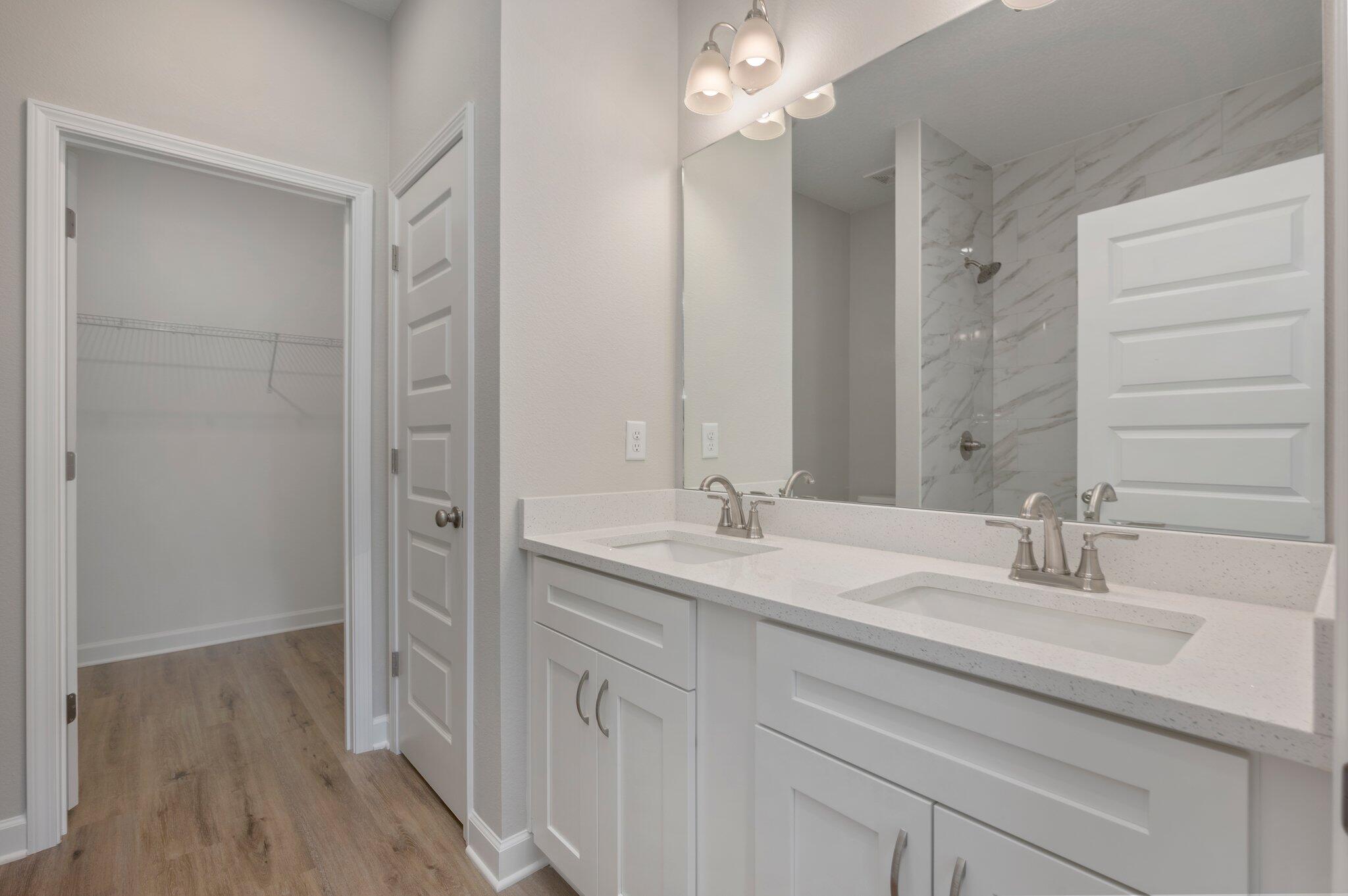 95 Live Oak Street Freeport, FL 32439 - Photo 24 of 26 a bathroom with a double vanity sink a mirror and a shower