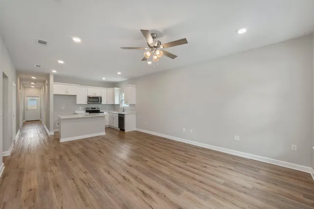 a view of kitchen with wooden floor and window