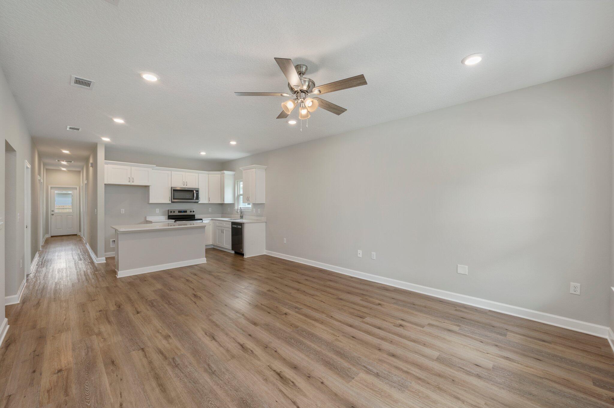 95 Live Oak Street Freeport, FL 32439 - Photo 5 of 26 a view of kitchen with wooden floor and window