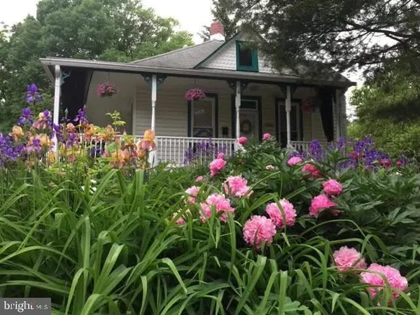 front view of a house with a lot of flower and the flowers