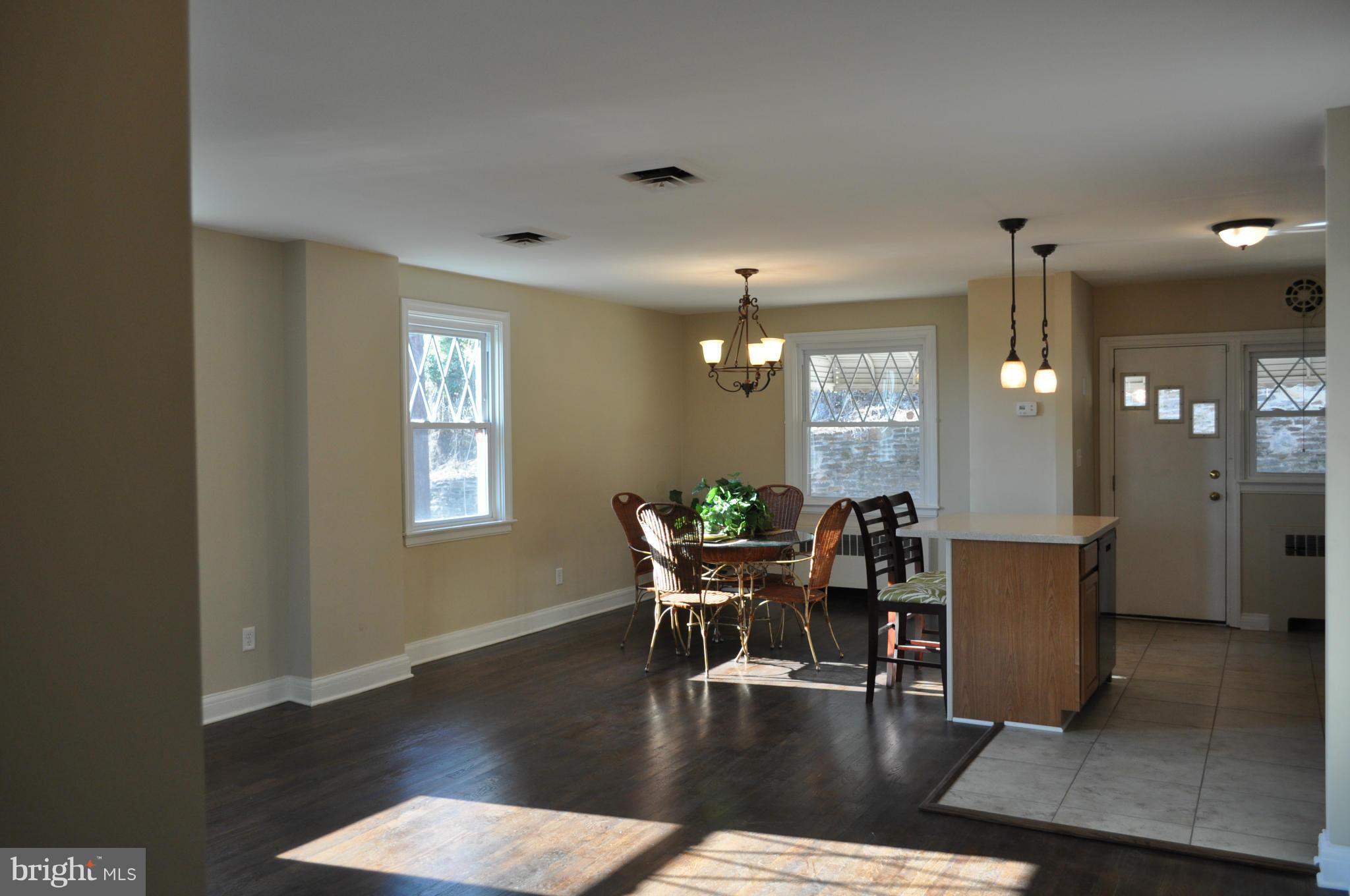 3900 Rexmere Road Baltimore, MD 21218 - Photo 2 of 23 a view of a dining room with furniture and wooden floor