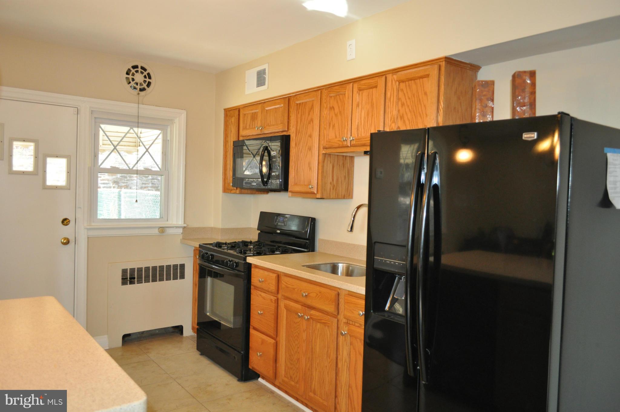3900 Rexmere Road Baltimore, MD 21218 - Photo 11 of 23 a kitchen with stainless steel appliances a refrigerator a stove a sink dishwasher and a refrigerator