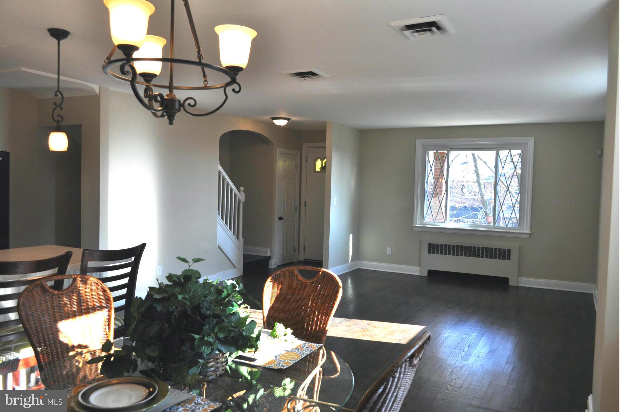3900 Rexmere Road Baltimore, MD 21218 - Photo 14 of 23 a view of a dining room with furniture a chandelier and wooden floor