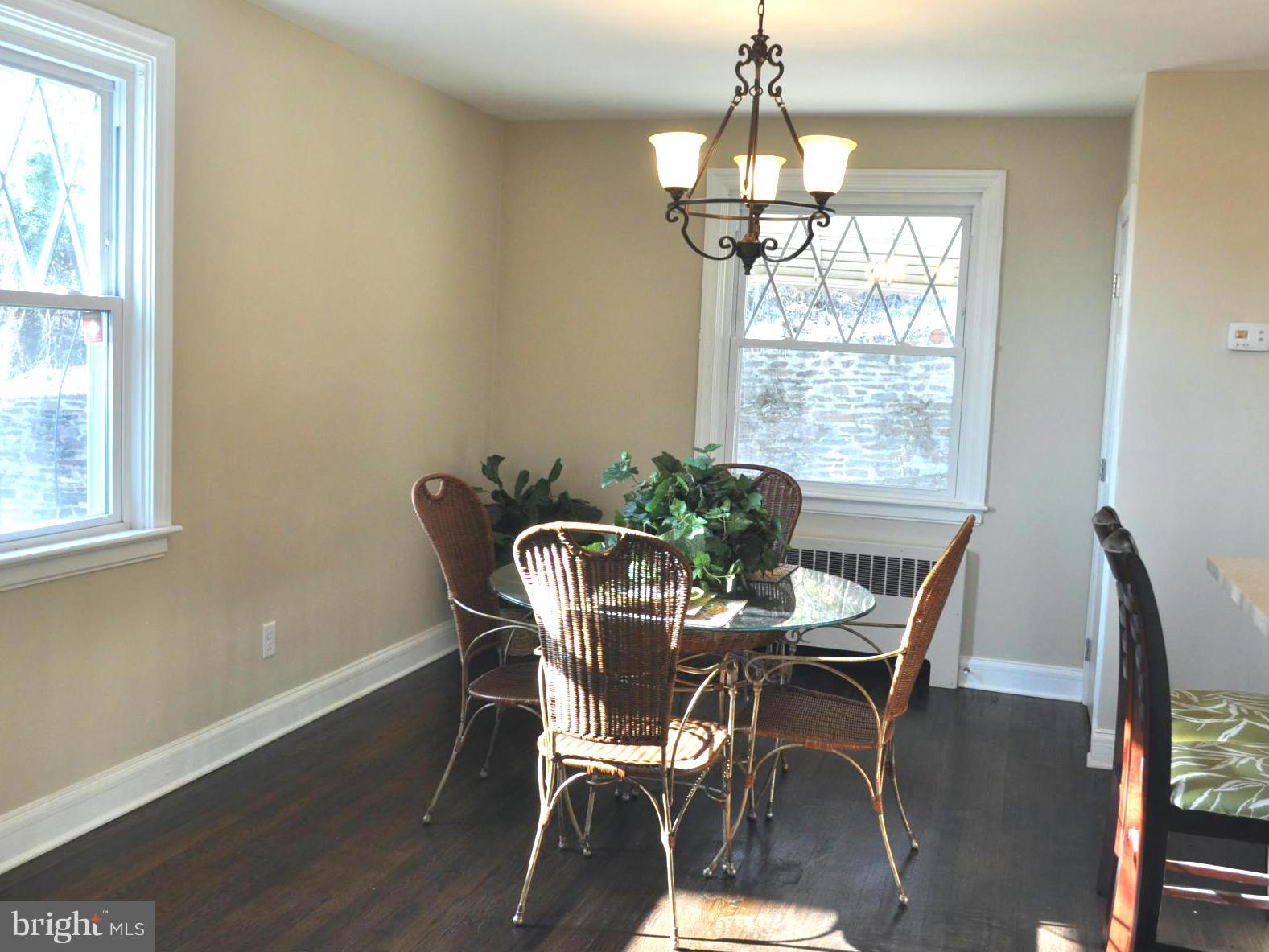 3900 Rexmere Road Baltimore, MD 21218 - Photo 15 of 23 a dining room with chandelier and wooden floor