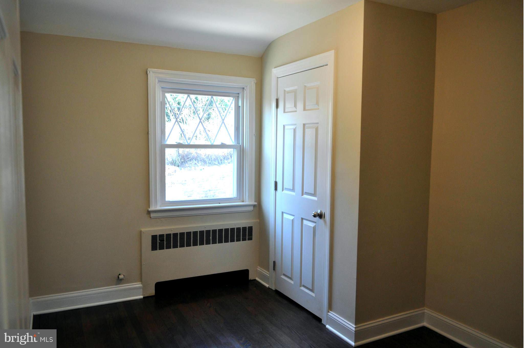 3900 Rexmere Road Baltimore, MD 21218 - Photo 18 of 23 an empty room with wooden floor and windows