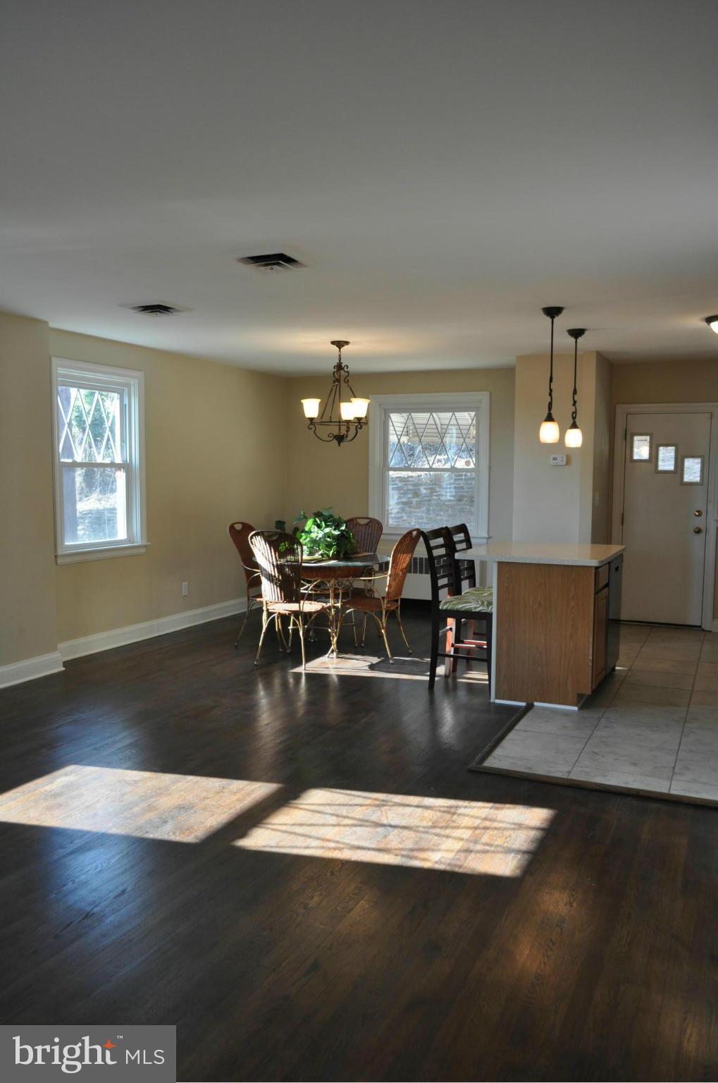 3900 Rexmere Road Baltimore, MD 21218 - Photo 3 of 23 a view of a dining room with furniture wooden floor and chandelier