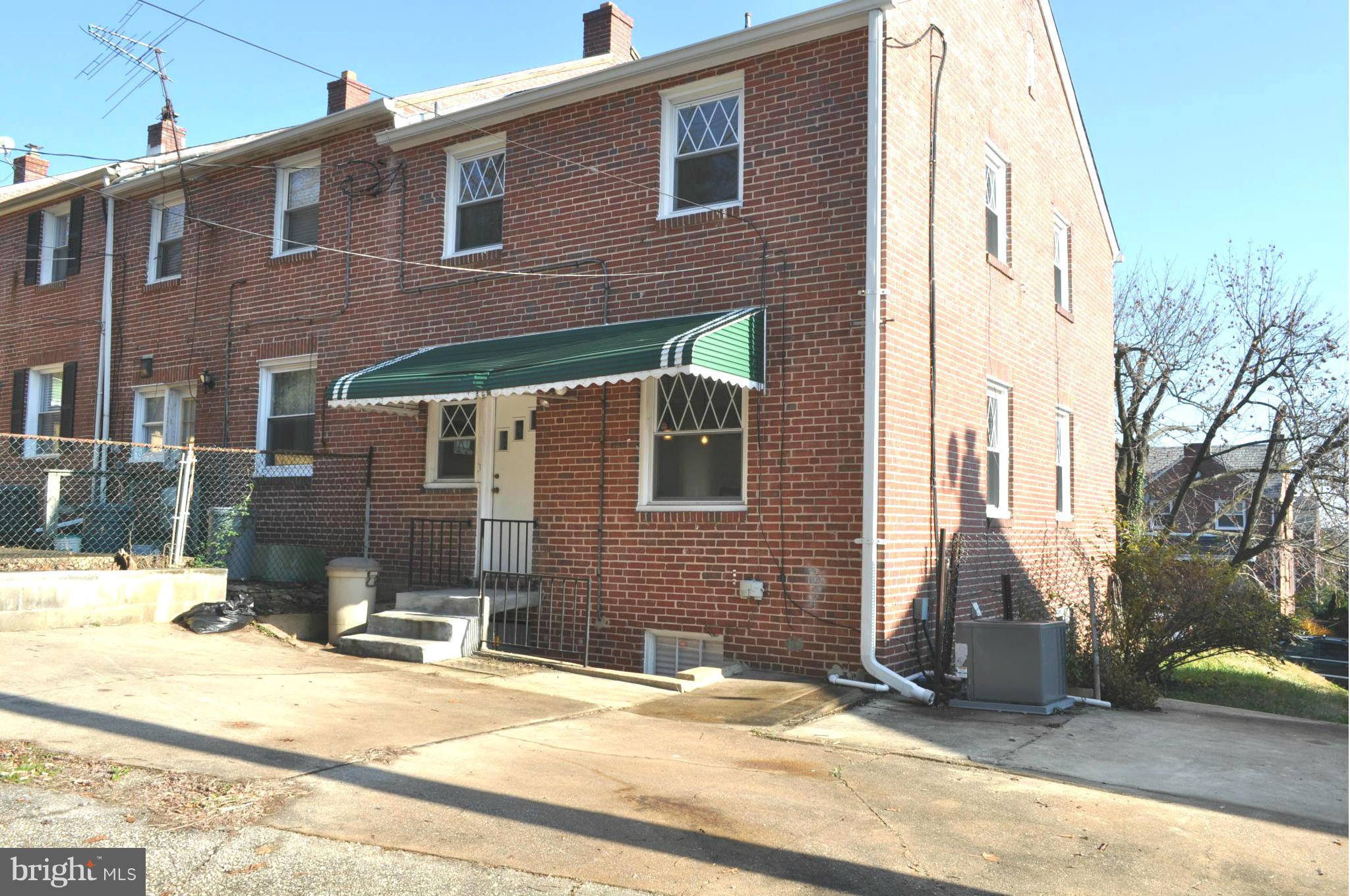 3900 Rexmere Road Baltimore, MD 21218 - Photo 21 of 23 a view of a brick house with many windows
