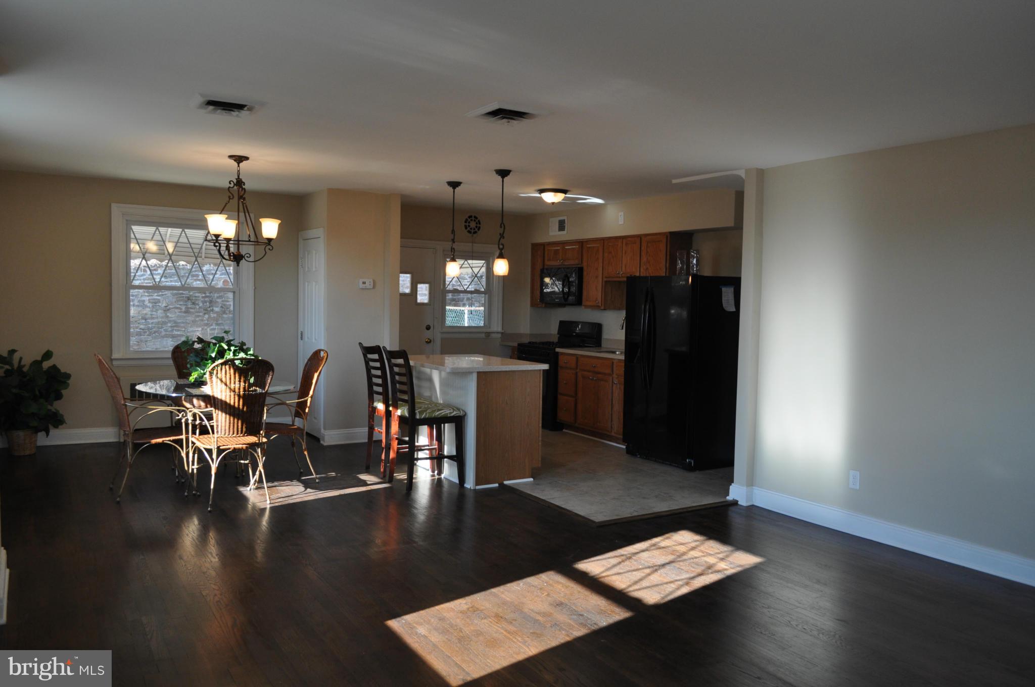 3900 Rexmere Road Baltimore, MD 21218 - Photo 4 of 23 a dining room with furniture and wooden floor