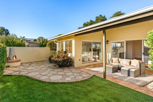 a view of a house with backyard and porch